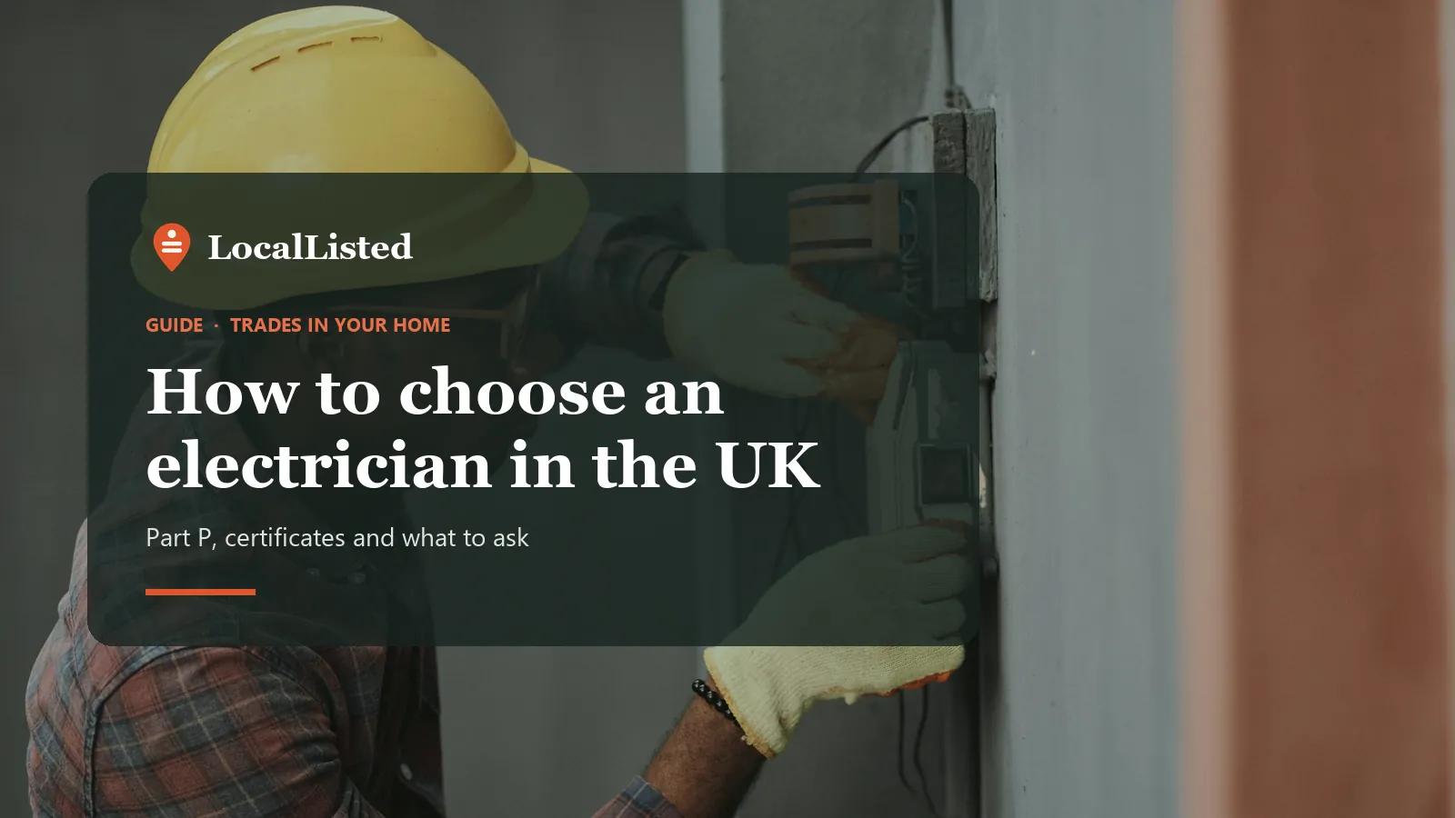 How to choose an electrician in the UK. Photo: an electrician in a hard hat installing wiring.